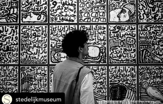 poems on the wall by the artist Sadik kwaish, explores the history of the Ahwari migration.